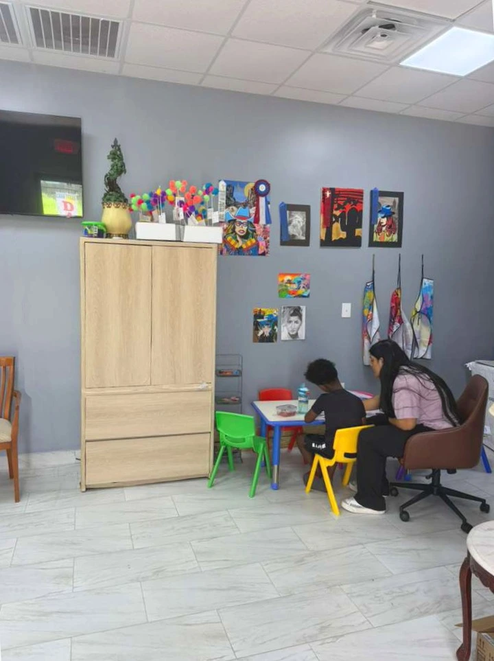 A tutor working one-on-one with a young student at SKY High